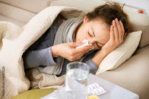 Photo: Sick Woman. Flu. Woman Caught Cold. Sneezing into Tissue Sick Woman. Flu. Woman Caught Cold. Sneezing into Tissue