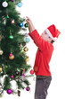 Young boy decorating Christmas tree, vertical shot