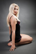 Foto: Beautiful woman wearing lingerie while kneeling on the floor Beautiful woman wearing lingerie while kneeling on the floor