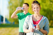 Photo: Man and woman drinking from bottle Man and woman drinking from bottle