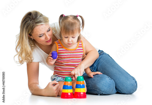 Photo: kid girl and mother playing together with cup toys kid girl and mother playing together with cup toys