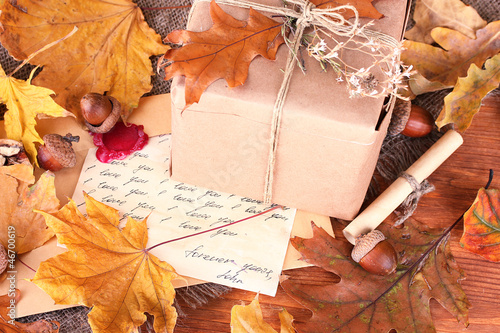 Photo: autumn background: vintage gift, letter and leaves autumn background: vintage gift, letter and leaves