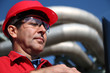 Engineer With Red Hard Hat and Pipelines