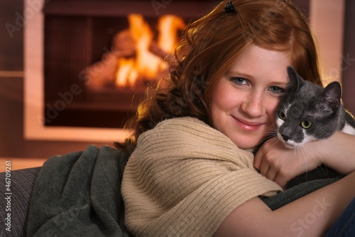Photo: Teenage girl loving cat at home Teenage girl loving cat at home