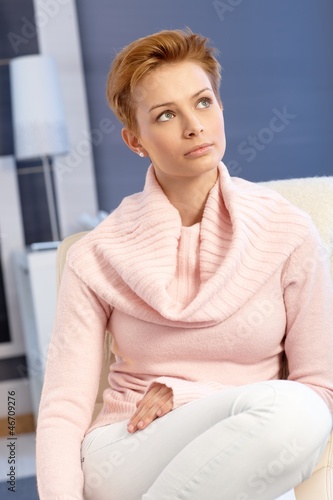 Photo: Young female daydreaming at home Young female daydreaming at home