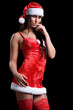 Photo: very sexy christmas woman with red santa look on black backgroun very sexy christmas woman with red santa look on black backgroun