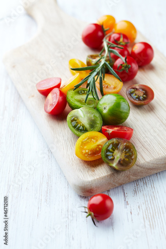 Photo: Assorted colorful cherry tomatoes on cutting board Assorted colorful cherry tomatoes on cutting board