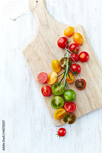 Photo: Assorted colorful cherry tomatoes on cutting board Assorted colorful cherry tomatoes on cutting board