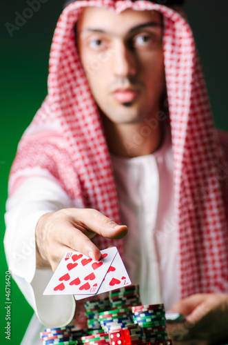 Photo: Arab playing in casino - gambling concept with man Arab playing in casino - gambling concept with man