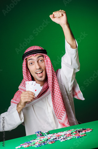 Photo: Arab playing in casino - gambling concept with man Arab playing in casino - gambling concept with man