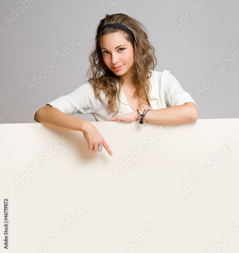 Photo: Young brunette woman with blank sign. Young brunette woman with blank sign.