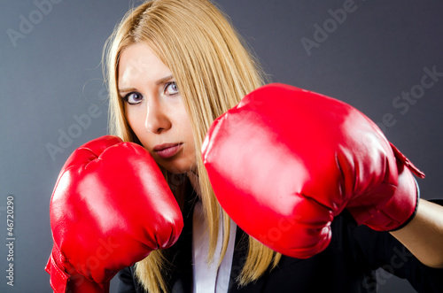 Photo: Woman boxer in dark room Woman boxer in dark room