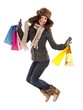 Happy woman with shopping bags jumping