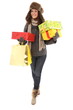 Woman in winter clothes with gifts and shopping bags smiling