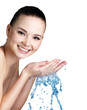 Photo : woman washing her face with water woman washing her face with water