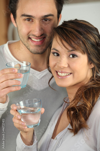 Photo: Couple drinking glasses of water Couple drinking glasses of water