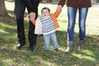 young happy family with child, outdoor portrait on natural backg