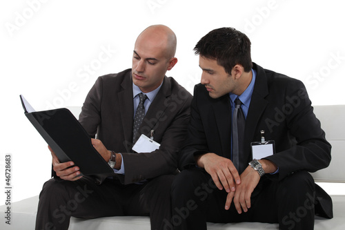 Photo: businessmen reading a report businessmen reading a report