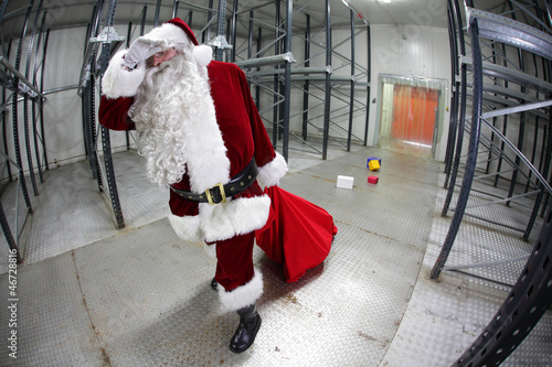 Photo: Tired Santa Claus loosing gifts from red sack Tired Santa Claus loosing gifts from red sack