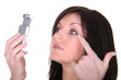 Brunette woman looking at mobile phone screen