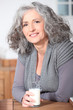 Photo: Older woman with a glass of milk Older woman with a glass of milk