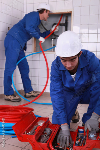 Photo: laborers installing tube laborers installing tube