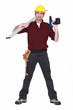 Worker with a cordless power drill