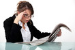 Woman staring at the newspaper in disbelief