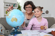 Mother helping daughter with geography homework