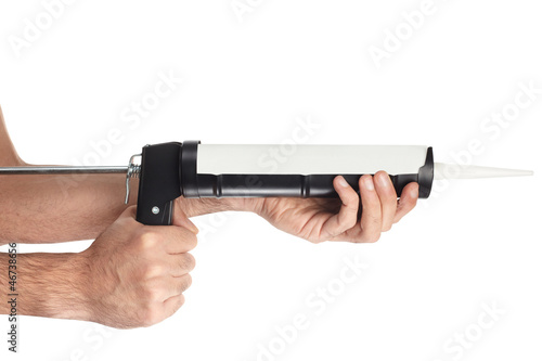 Photo: Caulking gun tool and hands on white with clipping path Caulking gun tool and hands on white with clipping path