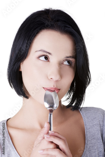 Photo: Woman with spoon in her mouth Woman with spoon in her mouth