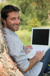 Happy man sitting outdoors