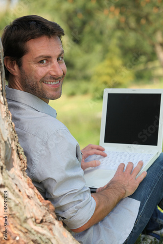 Photo: Happy man sitting outdoors Happy man sitting outdoors