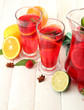 sangria in jar and glasses with fruits, on white wooden table