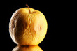 Yellow apple as problem skin concept, on black background