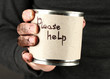 homeless man asks for help, on black background close-up