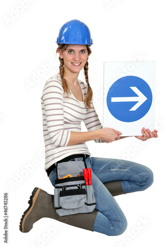 Photo: pretty blonde apprentice showing direction of construction site pretty blonde apprentice showing direction of construction site