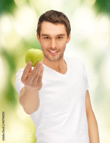 Photo: man in white shirt with green apple man in white shirt with green apple