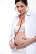 Pregnant woman listening to her baby's heartbeat