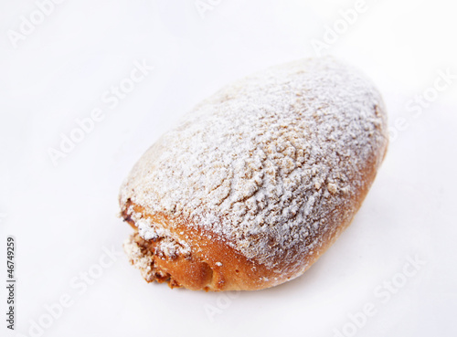 Photo: Baked bun dusted with powdered sugar Baked bun dusted with powdered sugar