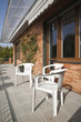 Photo: Three plastic chairs in a sunny terrace Three plastic chairs in a sunny terrace