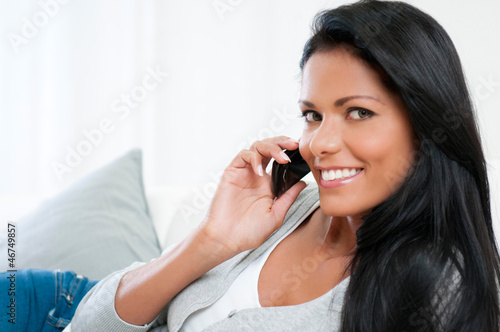 Photo: Young woman on mobile Young woman on mobile