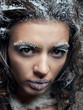 Portrait of young woman with snow make-up. Christmas snow queen