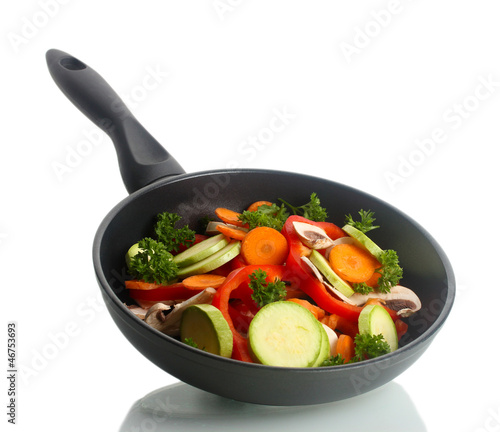 Photo: frying pan with vegetables on white frying pan with vegetables on white