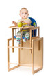 Baby sitting in highchair.