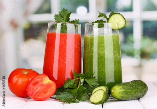 Photo: Fresh vegetable juices on wooden table, on window background Fresh vegetable juices on wooden table, on window background