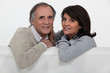 Mature couple sitting on a sofa