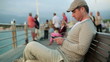Happy young man using smartphone on pier, steadicam shot 