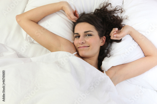 Photo: Brunette laid in bed Brunette laid in bed