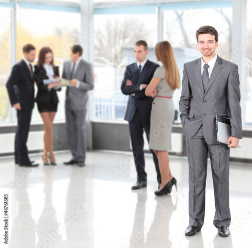 Photo: Happy smart business man with team mates discussing Happy smart business man with team mates discussing